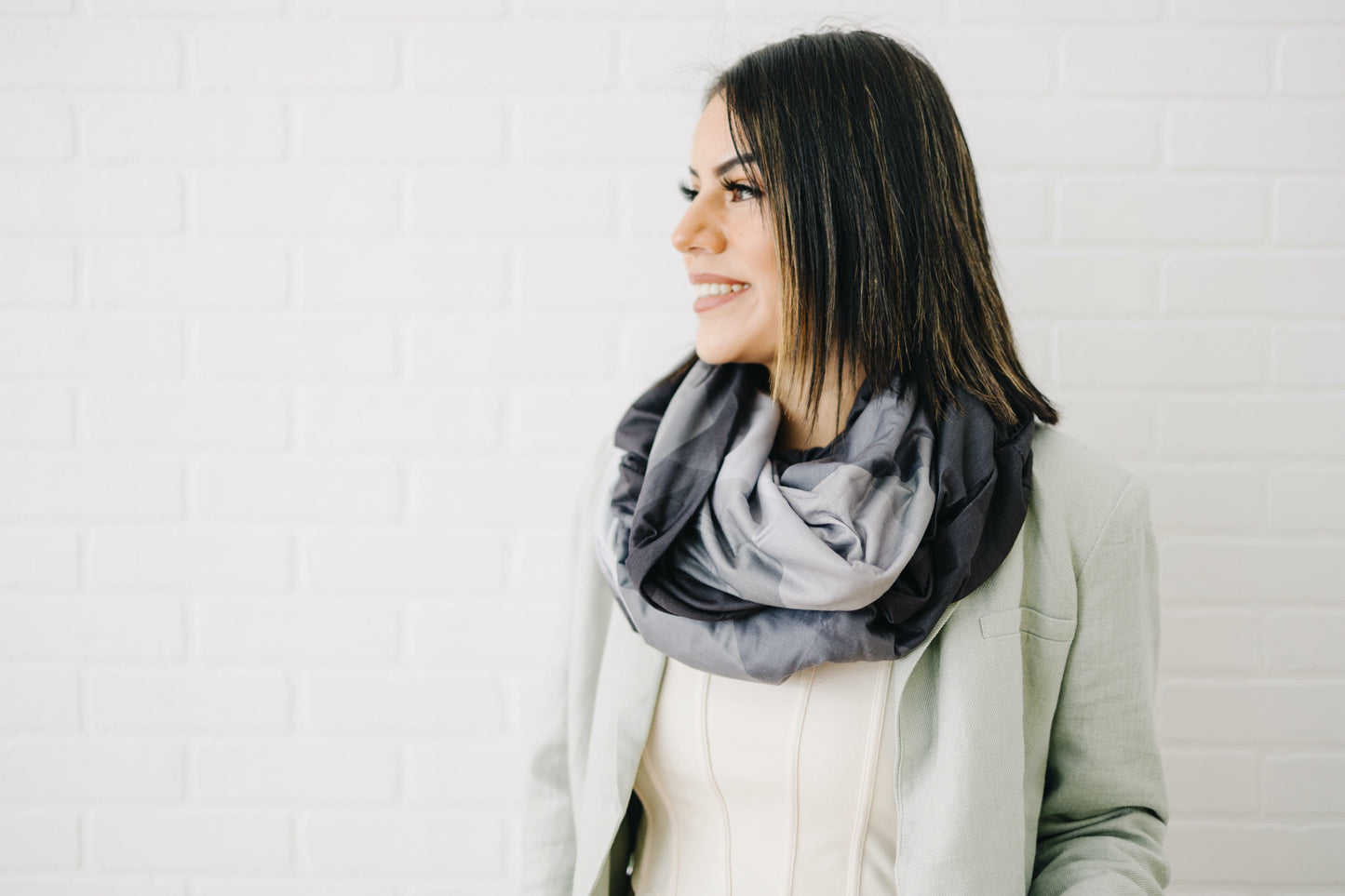 A women is wearing a waypoint goods travel scarf