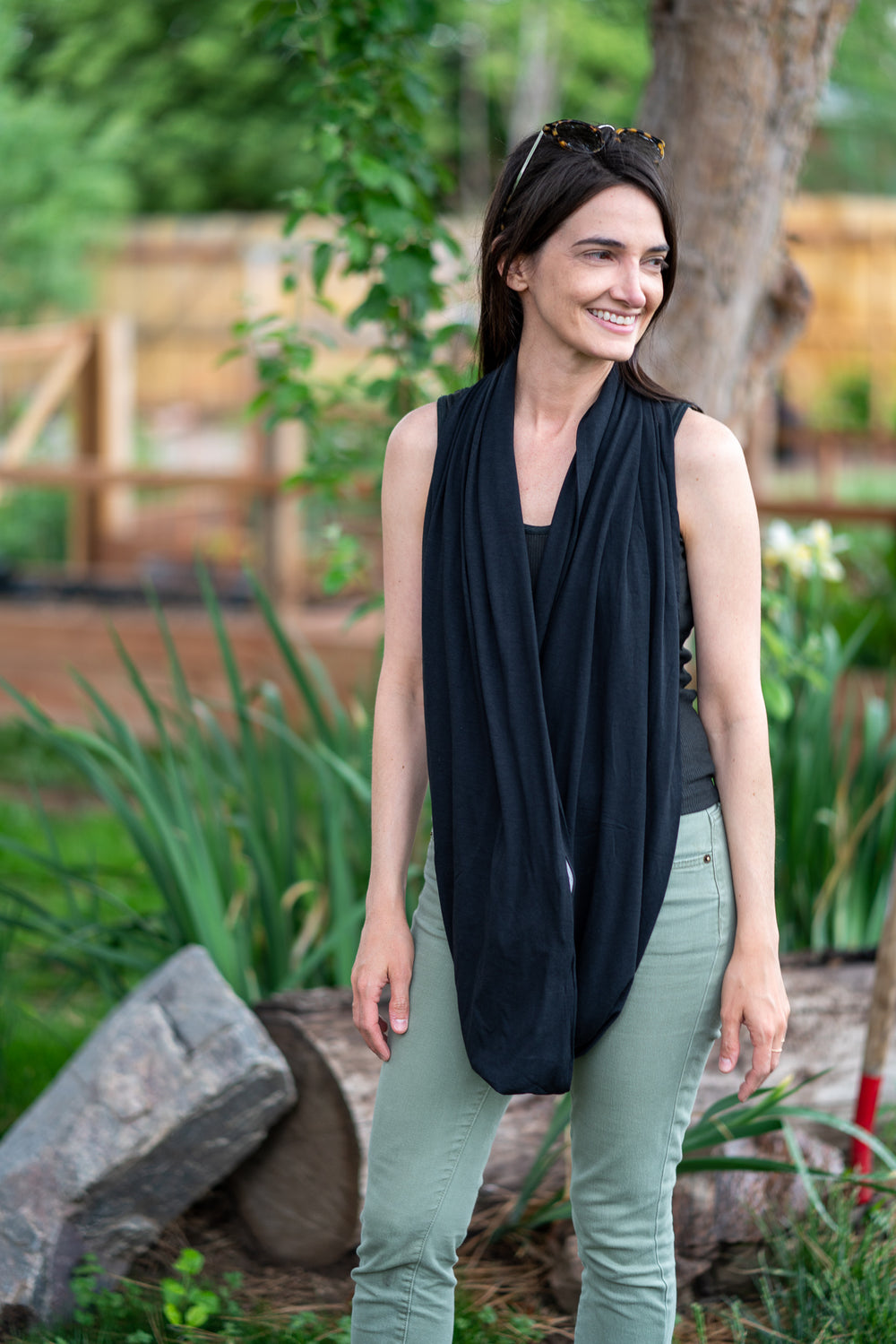 woman wearing carbon black  travel scarf by waypoint goods at an airport